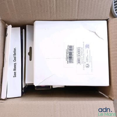 a box with a laptop inside of it sitting on the floor