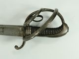 an old sword with a metal handle on a white surface