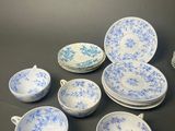 blue and white porcelain dishes and cups on a table