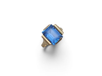 an 18k gold ring with a blue topaz stone