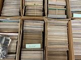 boxes full of old records are stacked on top of each other