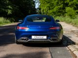 a blue car that is parked on the side of the road