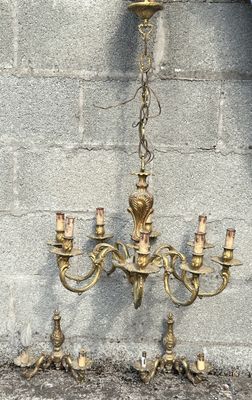 un lustre suspendu à une chaîne fixée à un mur en briques