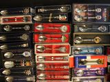a lot of silver spoons and spoons on a table