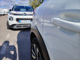 cars parked in a parking lot next to each other on a sunny day
