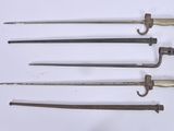 four different types of swords are displayed on a white surface
