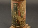 a vase with a painting on it sitting on a wooden stand