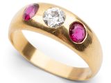 a close up of a gold ring with pink and white stones