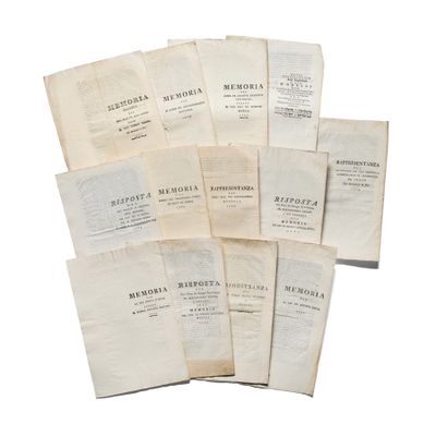 several old books are stacked on top of each other on a white surface