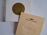a gold stamp on top of a white box