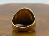 a gold ring sitting on top of a wooden table