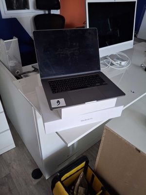 a laptop computer sitting on top of a white desk