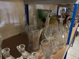 many glass vases on a shelf in a room