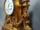 a gold clock that is sitting on a table