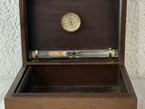 a wooden box with a clock inside of it