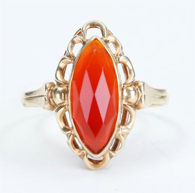 an image of a gold ring with an orange stone in it