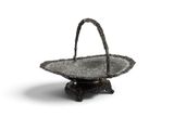an antique silver plate with a handle on a stand
