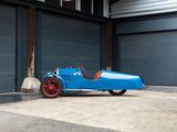 a blue car parked in front of a garage door