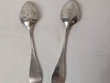 two spoons that are sitting on a table