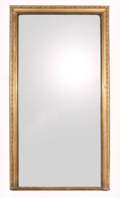 a gold framed mirror with a white background and a white wall