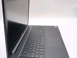 a laptop with a black keyboard on a white surface