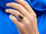 an image of a woman ' s hand with a ring on it