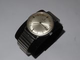 a watch that is sitting on a white surface