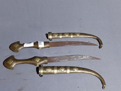 three knives that are sitting on a table next to each other