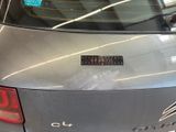 a car with a sticker on the back of it ' s trunk