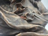 a close up of a statue of a woman holding a flower