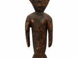 an image of a wooden statue of a person with a face and arms