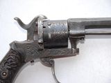 a gun that is sitting on a white surface