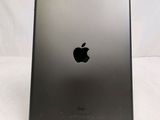 the back of an apple ipad with a black apple logo on it