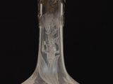 a clear glass vase sitting on top of a wooden table