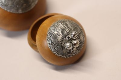 two wooden knobs with metal decorations on them