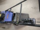 a lawn mower that is sitting on the ground