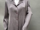the mannequin is wearing a gray jacket and black pants