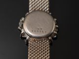a close up of a watch on a black surface