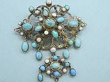 a close up of a broochle with pearls on it