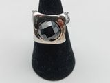a close up of a ring on a cone on a white surface
