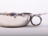 an image of a silver bowl with a spoon in the middle of it