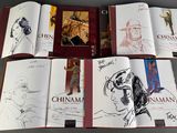 several books with drawings of people on them sitting on top of a table