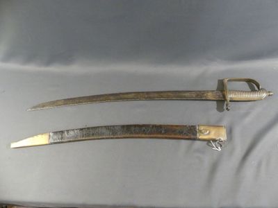 pair of two old swords with metal handles on a white cloth
