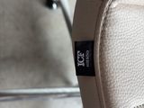 a close up of a white chair with a black label on it