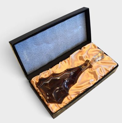 a bottle of liquor in a box on a white surface