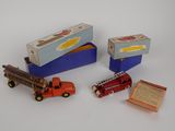 three toy trucks and a box of matches on a table