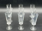 four wine glasses sitting on a table next to each other