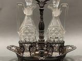 a silver tray with three crystal decanters on it