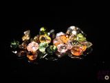 several different colored stones are arranged on a black surface