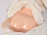 a white cloth wrapped around a pink object on a white surface